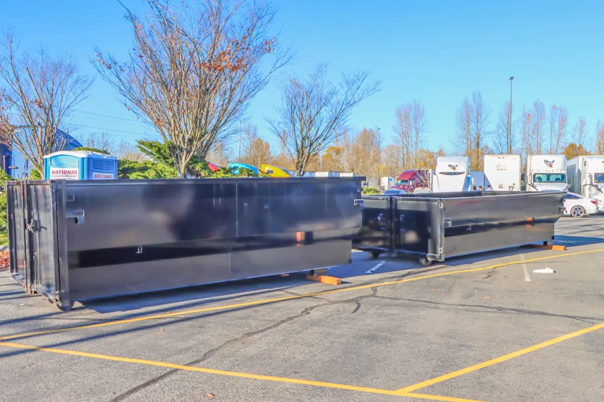 Professional dumpster rental service with roll-off container on residential driveway in Greenbelt